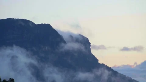 Clouds Moving Below Mountain Long-Shot Stock Footage 251504309