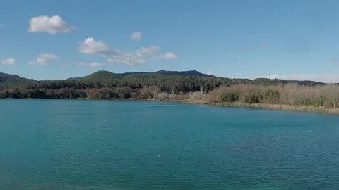 Clouds moving in a blue sky over a lake. Banyoles Lake, Catalonia Stock Footage 233069285
