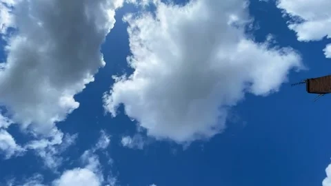 Clouds moving in clean blue sky time lapse video Stock Footage 180007352