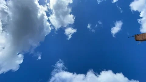 Clouds moving in clean blue sky time lapse video Stock Footage 180007555