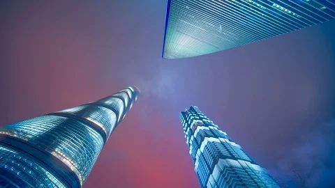 Clouds moving close to towers a look up timelapse clip at night in Shanghai Stock Footage 104712804