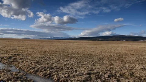 Clouds moving fast above field. Stock Footage 86734295
