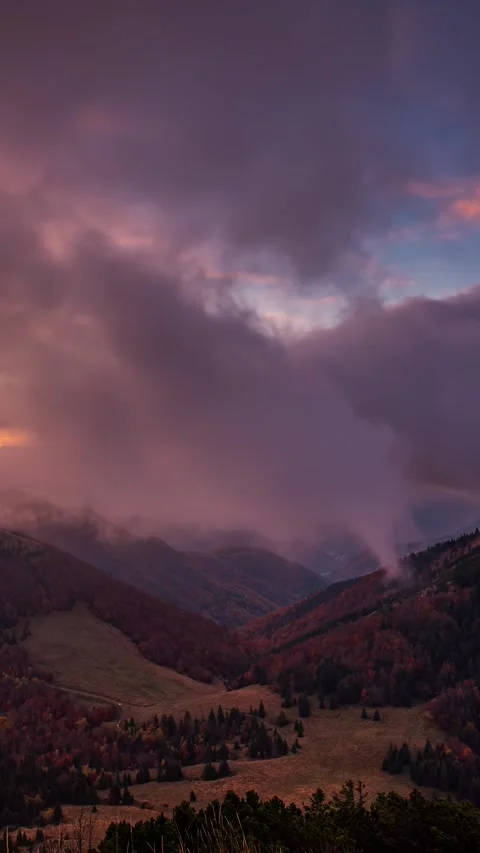 Clouds moving fast in autumn mountains before sunrise, vertical video Video stock 277029740