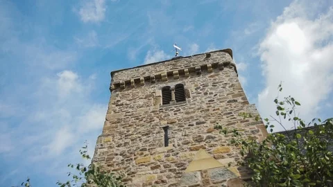 Clouds moving fast in a blue sky behind a church steeple 库存影片 99402620