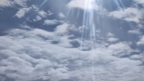 Clouds moving fast with blue sky and shiny sun rays 4k video Stock Footage 295924626