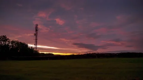 Clouds moving fast during sunset with orange sky Video stock 141386901