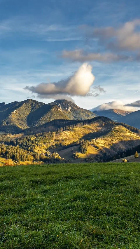 Clouds moving fast over alps mountains nature at sunset vertical time lapse Stock Footage 293075331