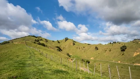 Clouds moving fast over green Zealand country Time lapse Stock Footage 104247498