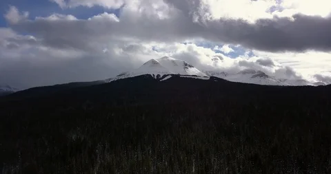Clouds moving fast over snowy mountain peak in southern Colorado Stock Footage 101613871
