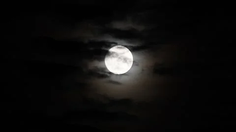 Clouds moving in front of full moon Stock Footage 257028411