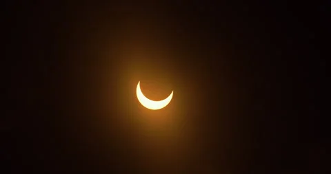 Clouds moving in front of a partial annular eclipse, October 14th, 2023. Stock Footage 253371220