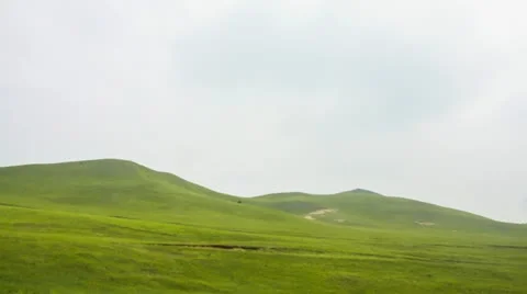 Clouds moving with meadow background,timelapse. Stock Footage 22257633