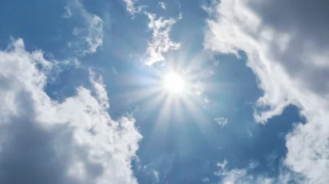 Clouds moving over bright sun shining in blue sky background. Timelapse view. Stock Footage 50126345