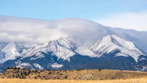 Clouds moving over Crazy Mountains peaks timelapse Stock Footage 310536862