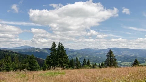 Clouds moving over forest country in sunny day in carpathian nature Time lapse Stock Footage 107876867