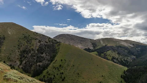 Clouds moving over grassy mountains Stock Footage 167532641