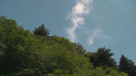 Clouds Moving over a Green Hill with a Blue Sky Stock Footage 12746099