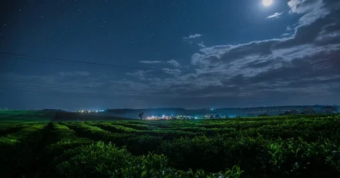 Clouds moving over green landscape Stock Footage 72985429