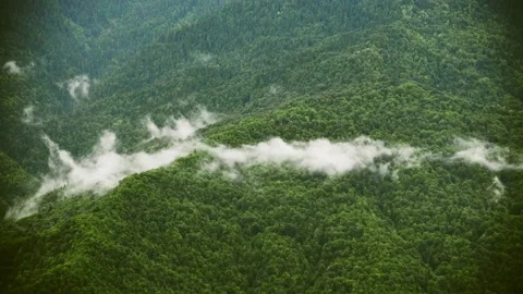 Clouds moving over the green mountains timelapse. Video stock 234068575