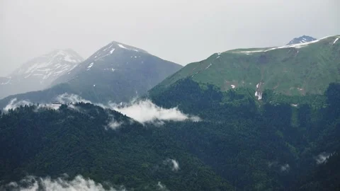 Clouds moving over the green mountains timelapse. Video stock 234068601