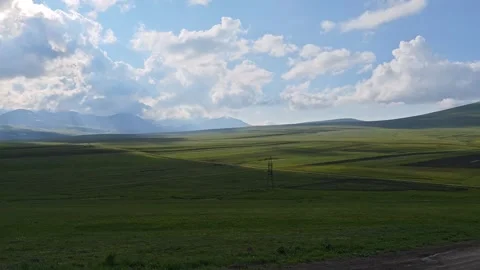 Clouds moving over green valley and lake with mountains Vidéo 311406389