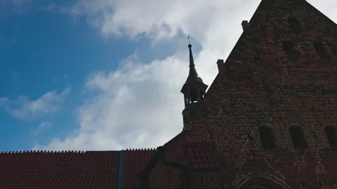 Clouds moving over historic gables and tower of a medieval cathedral Stock Footage 333280914