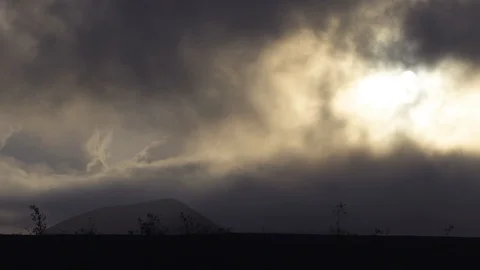Clouds moving over landscape during sunset Stock Footage 85816882