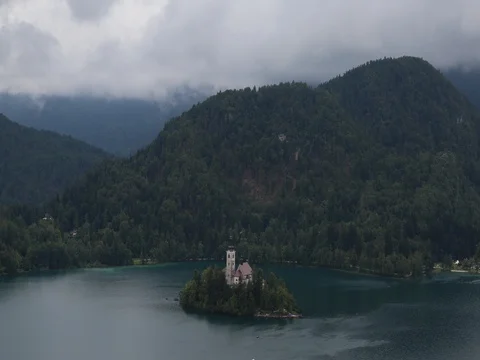 Clouds moving over mountain and boats sailing in lake Stock Footage 69464676