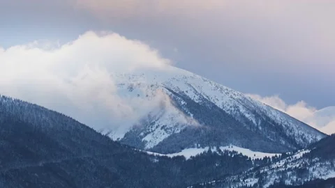 Clouds moving over the mountain during twiligh in winter landscape. Timelapse Video stock 230922015
