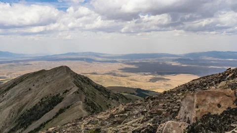 Clouds moving over mountain landscape moving shadows across land Stock Footage 167530567