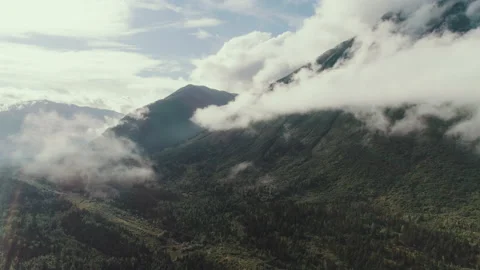 Clouds moving over a mountain peak Stock Footage 154524800