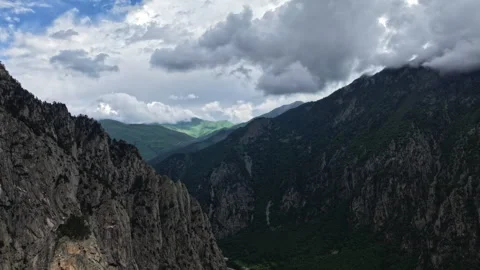 Clouds moving over mountain valley timelapse Stock Footage 318867714
