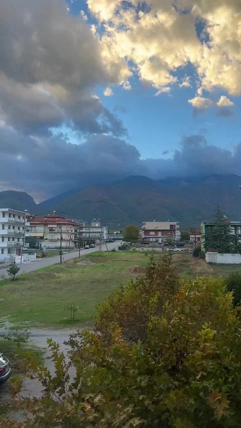 Clouds moving over mountainous village landscape at sunset Stock Footage 322043774