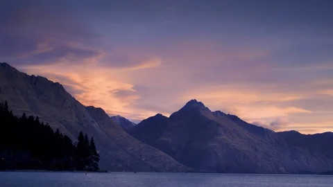 Clouds moving over mountains and Wanaka lake Stock Footage 76104577
