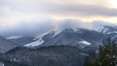 Clouds moving over the mountains during twilight in winter landscape. Tiemlapse 動画素材 230921403