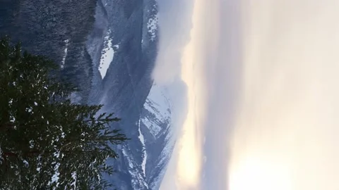 Clouds moving over the mountains during twilight in winter landscape. Vertical Stock Footage 230922169