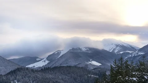 Clouds moving over the mountains during twilight in winter landscape. Tiemlapse Stock Footage 232025860