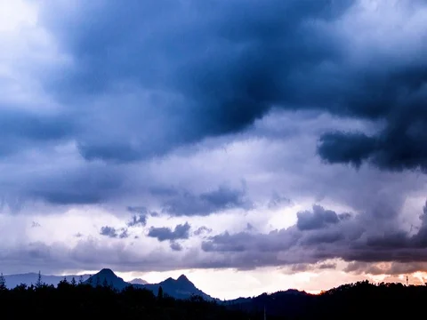 Clouds moving over mountains at dusk Stock Footage 76101264