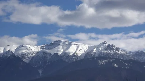 Clouds moving over the mountains full of snow Stock Footage 56087783