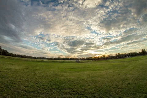 Clouds moving over an open field at sunset timelapse Video stock 348050093