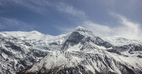 Clouds moving over peaks of snow-capped mountains Stock Footage 79605087