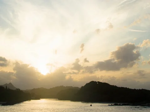Clouds moving over river and mountainous region during sunrise Stock Footage 76101316