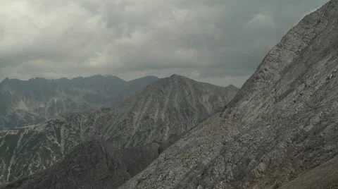 Clouds Moving Over Rocky Mountain Slopes 4K Stock Footage 67477766