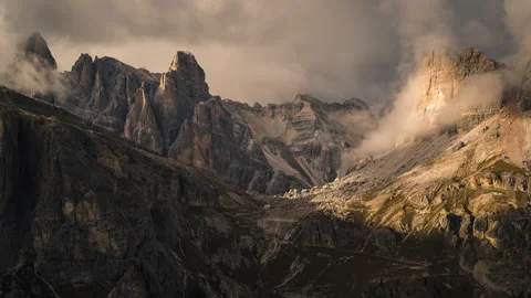 Clouds moving over the rocky mountain peaks of the dolomites in Italy Stock Footage 143314532