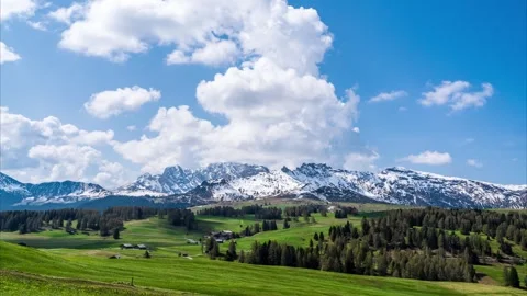 Clouds moving over rugged mountains and alpine meadows. Italian Alps (Timelapse) Stock Footage 244744577