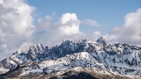 Clouds moving over rugged, snow capped mountains. Italian Alps (Timelapse) Stock Footage 244744842