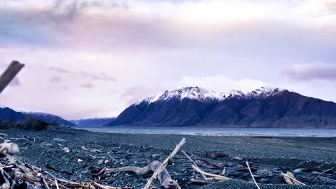 Clouds moving over snow covered mountains and Wanaka lake Stock Footage 76103454