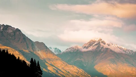 Clouds moving over snow covered mountains Stock Footage 76199449