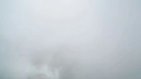 Clouds moving over snow covered mountain Stock Footage 77483347