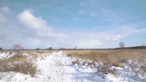 Clouds moving over snowy path through winter landscape Stock-Footage 293082072